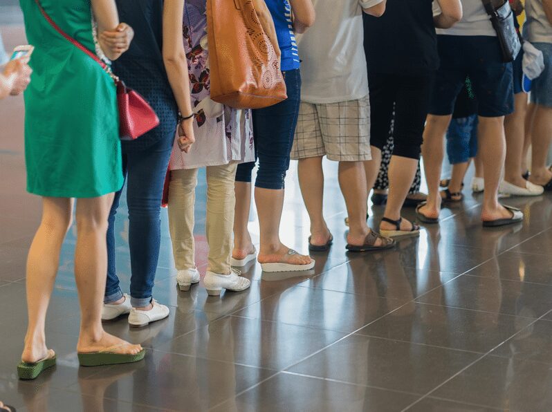 Close-up of people waiting in line