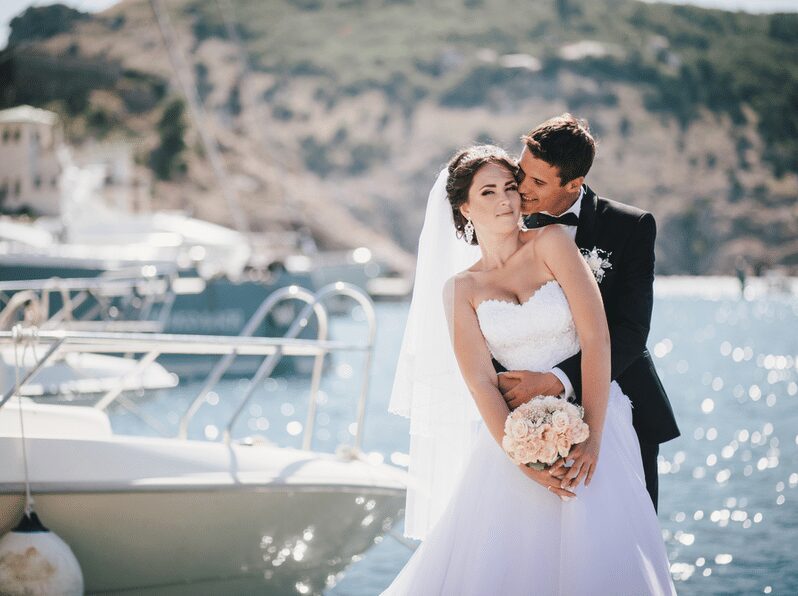 Newlyweds taking picture on boat docks